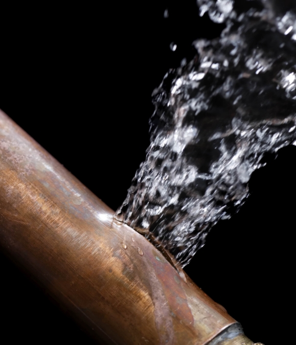 A water pipe with splashing water coming out of it.